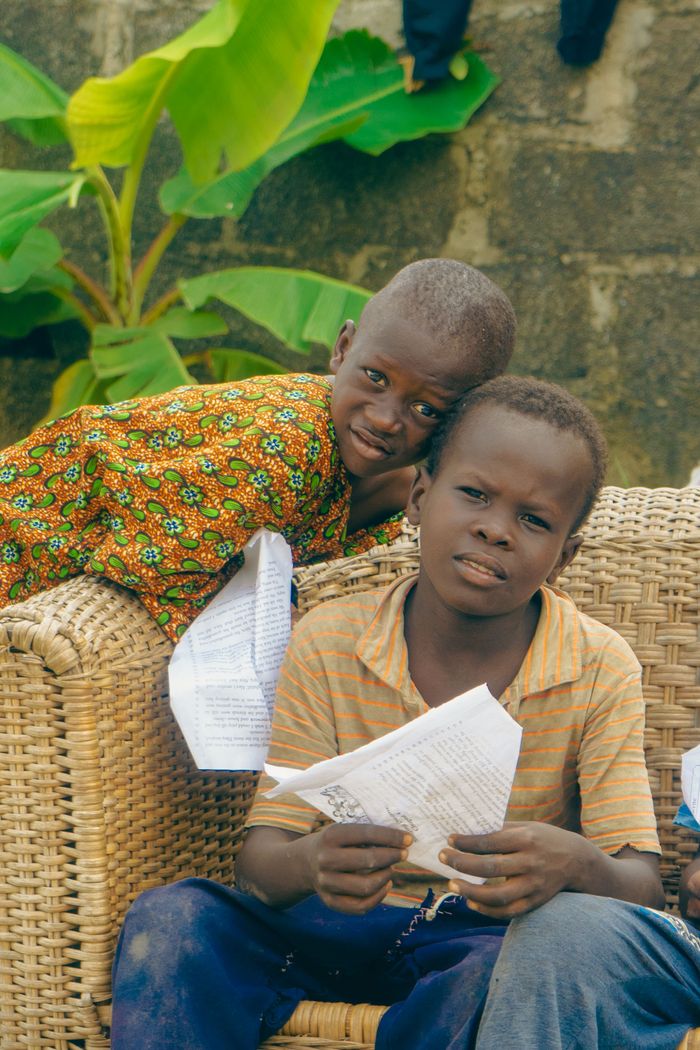 Services Two children enjoy reading together outside, showcasing friendship and learning.